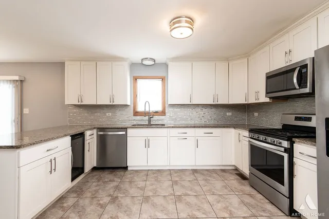 a kitchen with granite countertop cabinets stainless steel appliances and a sink