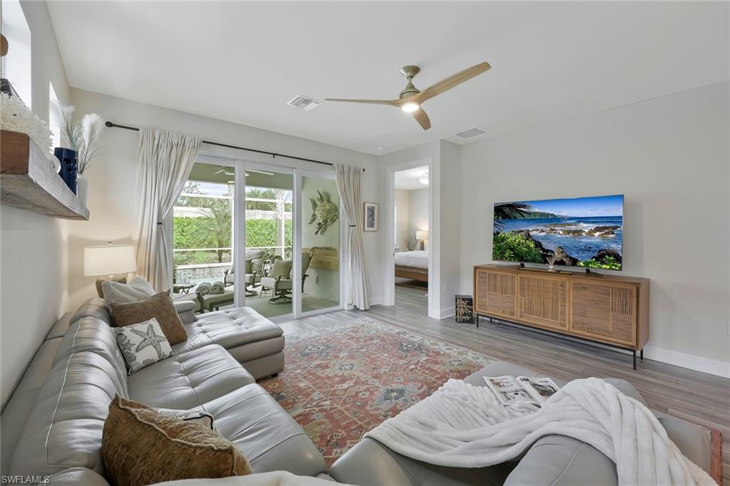 10787 Manatee Key Lane Estero, FL 33928 - Photo 6 of 31 a living room with furniture and a large window