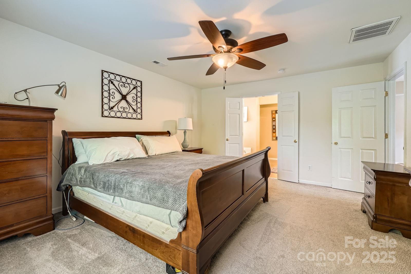10132 Caldwell Depot Road Cornelius, NC 28031 - Photo 16 of 28 a bedroom with a bed and cabinet