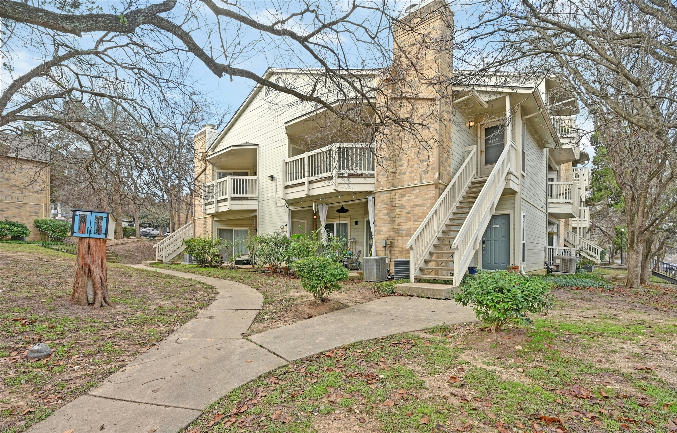 2450 Wickersham Lane, Unit 710 Austin, TX 78741 - Photo 3 of 20 a front view of a house with a yard