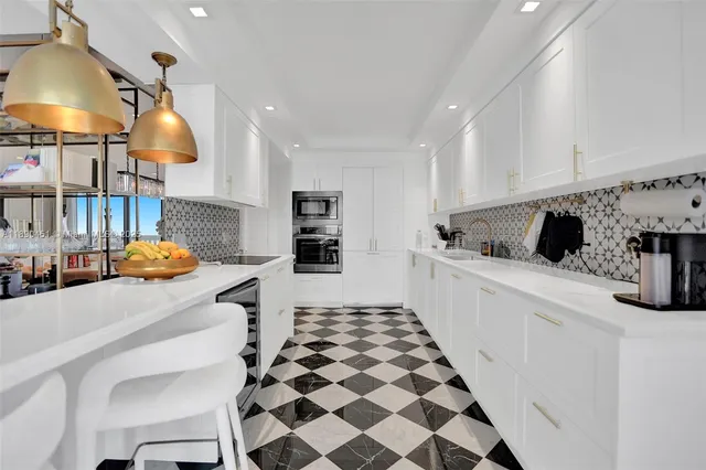 a kitchen with granite countertop a sink a counter space and cabinets