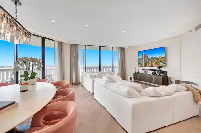 a living room with furniture and a chandelier