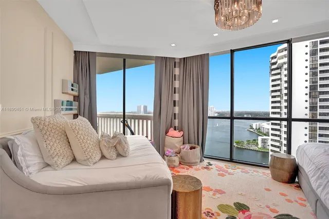 a spacious bedroom with a large bed and a large window