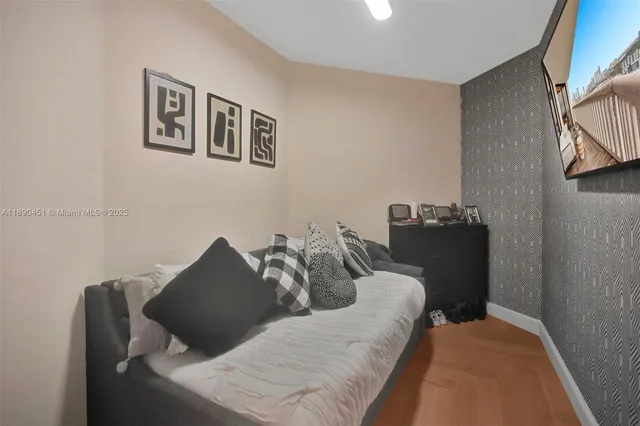 a bed sitting in a bedroom next to a lamp