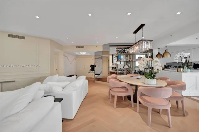 a living room with furniture and a dining table