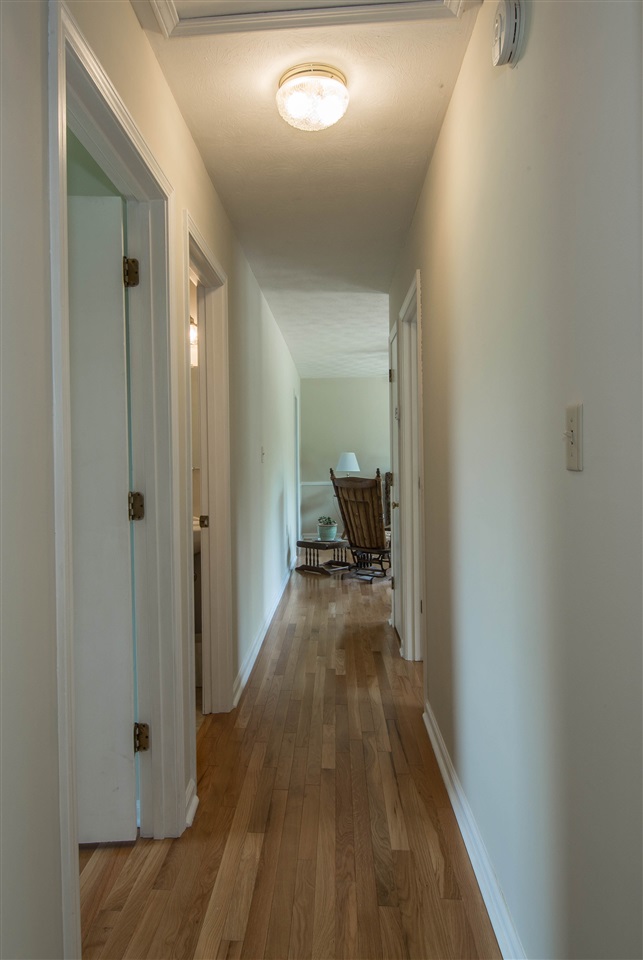 2638 Spaders Church Road Harrisonburg, VA 22801 - Photo 19 of 19 a view of a hallway with wooden floor and a bathroom