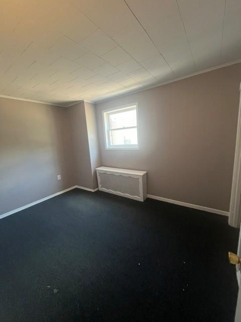 126 East High Street Coaldale, PA 18218 - Photo 12 of 15 A cozy retreat awaits, featuring plush carpeting and a radiator cover, perfect for quiet enjoyment.