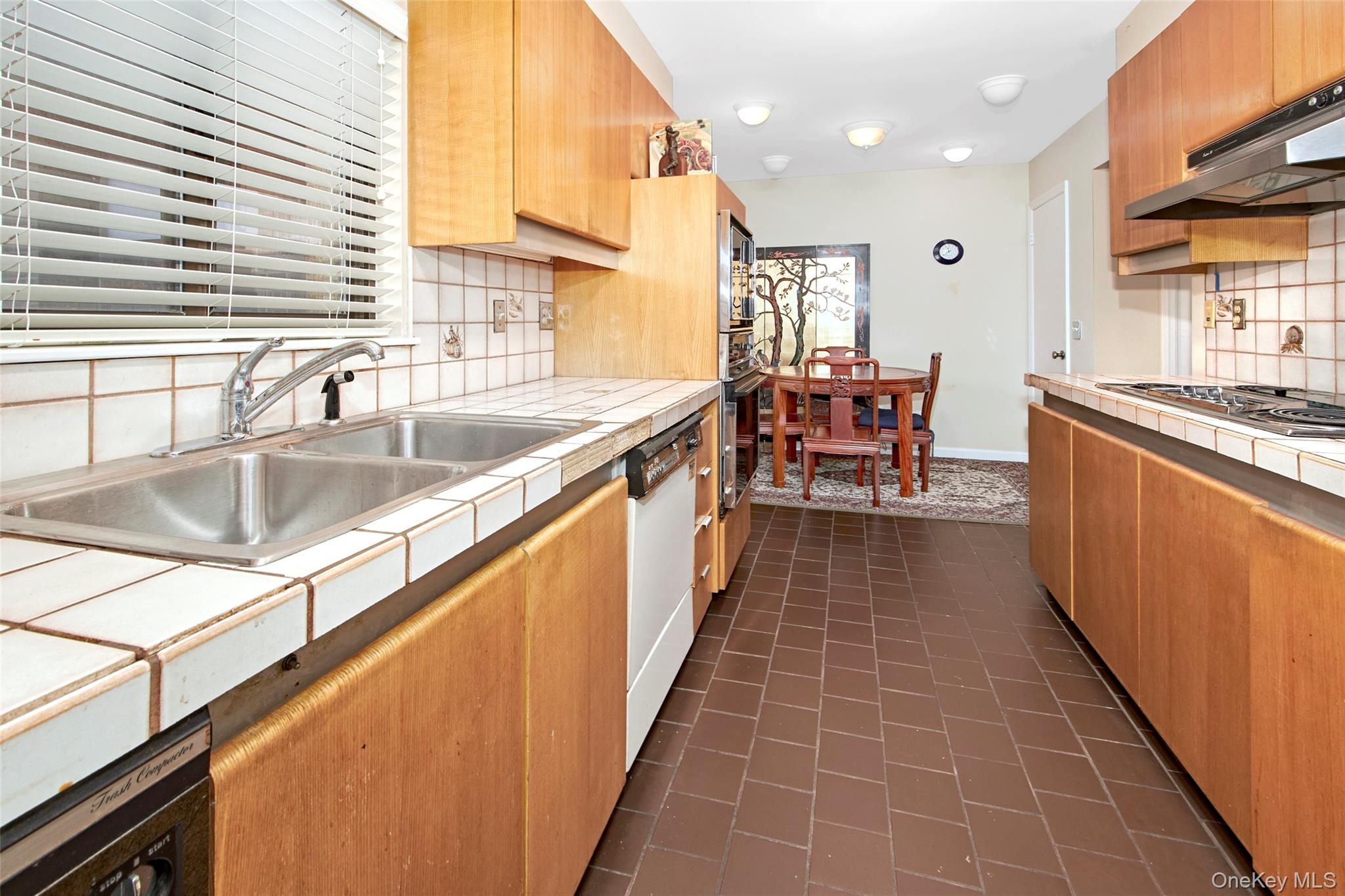 21 Waters Edge, Unit 21 Rye, NY 10580 - Photo 15 of 29 a kitchen with stainless steel appliances granite countertop a sink and a wooden cabinets