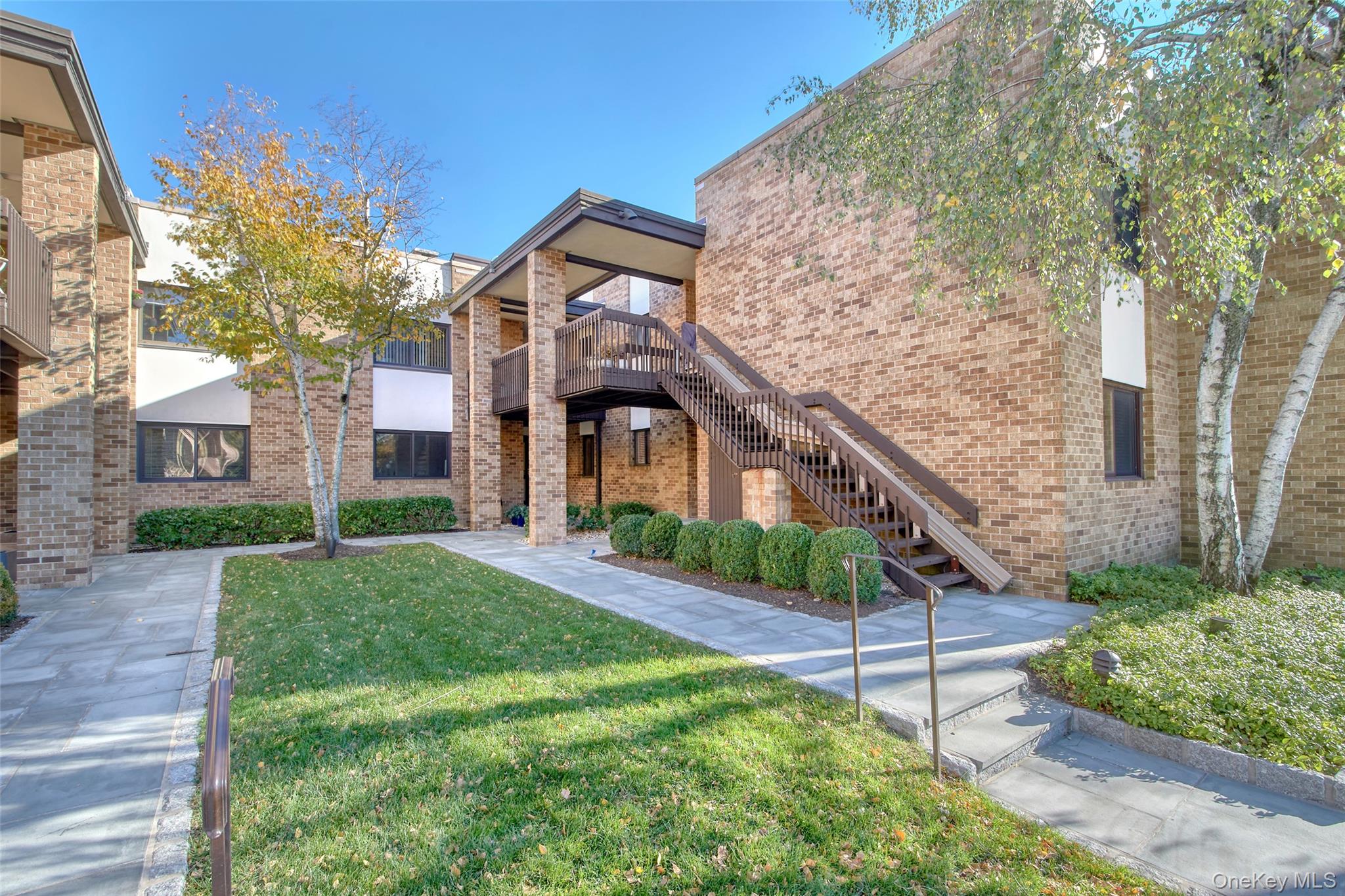 21 Waters Edge, Unit 21 Rye, NY 10580 - Photo 2 of 29 a front view of a house with a yard