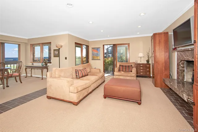 a living room with furniture a flat screen tv and a fireplace