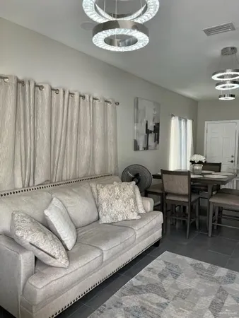a living room with furniture a rug and a window