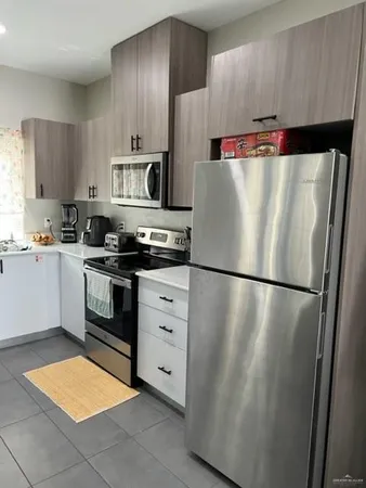 a white refrigerator freezer sitting in a kitchen
