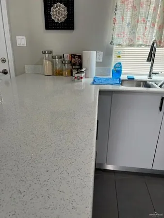 a kitchen with stainless steel appliances a sink and a refrigerator
