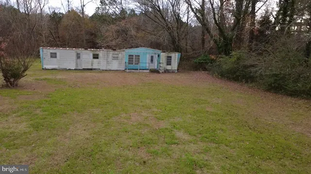 a view of a swimming pool with a yard and mountain view
