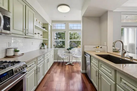 a kitchen with sink stove and cabinets