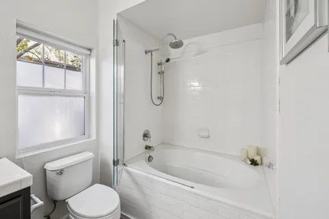 a bathroom with a toilet and shower