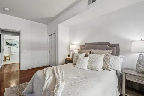 a bedroom with a bed and wooden floor