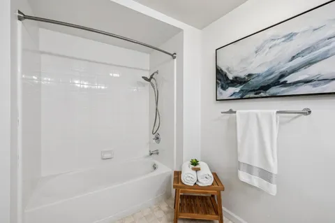 a bathroom with a tub and shower