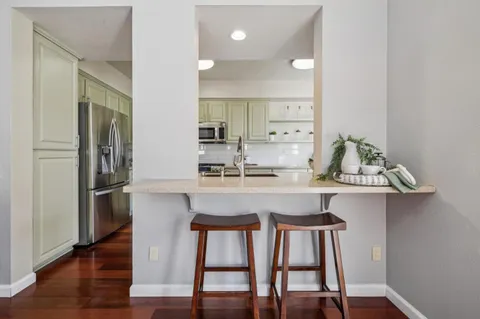 a kitchen with kitchen island a table and chairs in it
