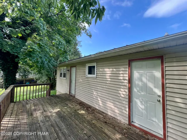 a view of a house with a wooden deck
