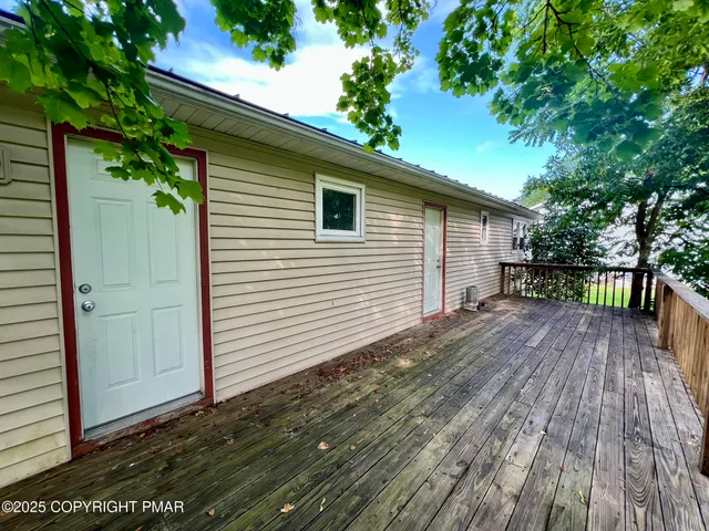 a view of a balcony with wooden floor