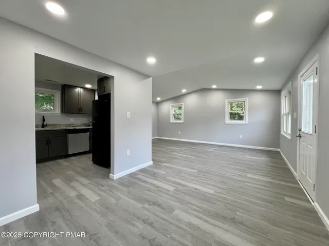 a view of a kitchen with a sink and cabinets