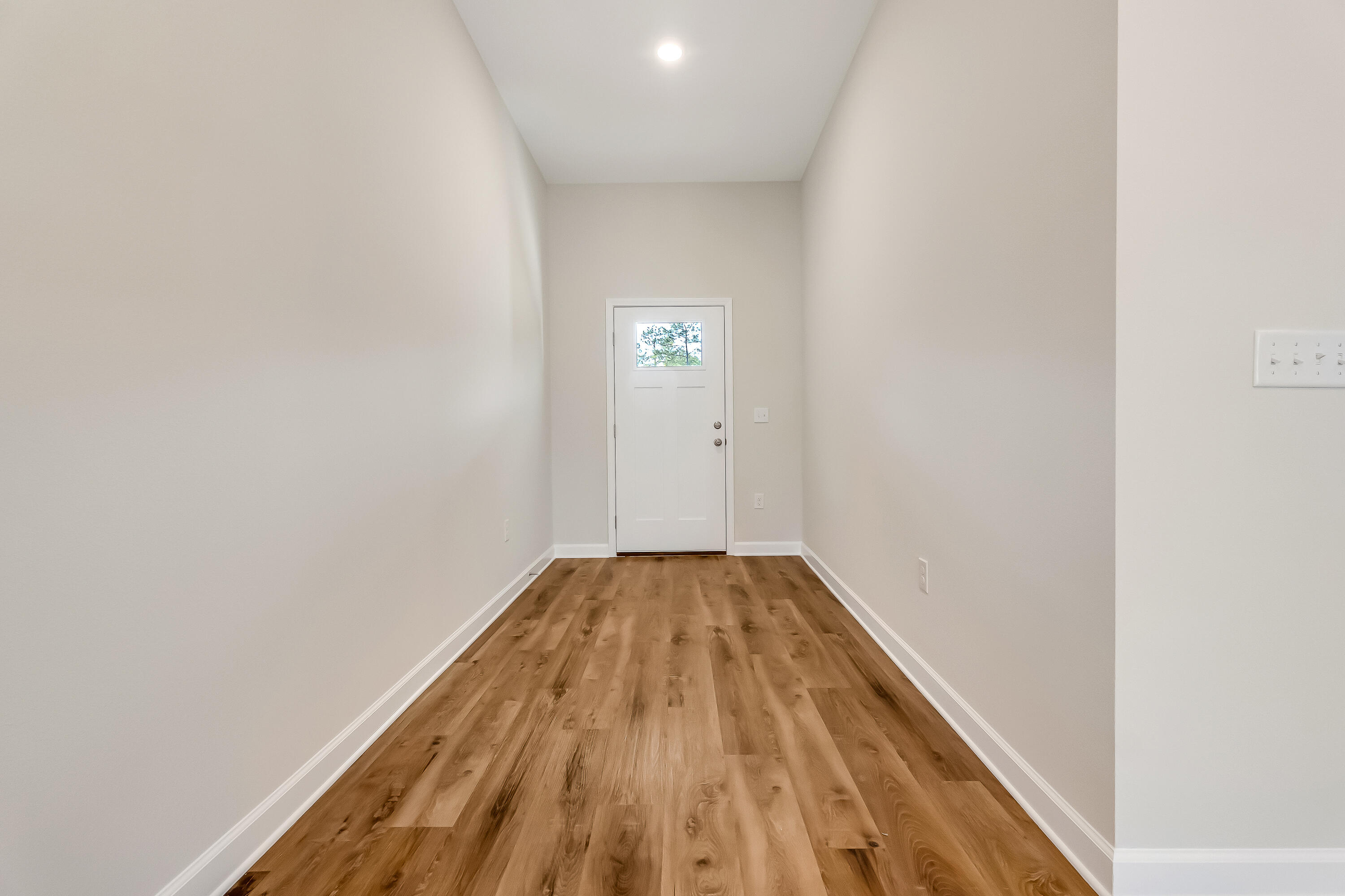 108 Huron Trail Crestview, FL 32536 - Photo 3 of 21 a view of a hallway with wooden floor