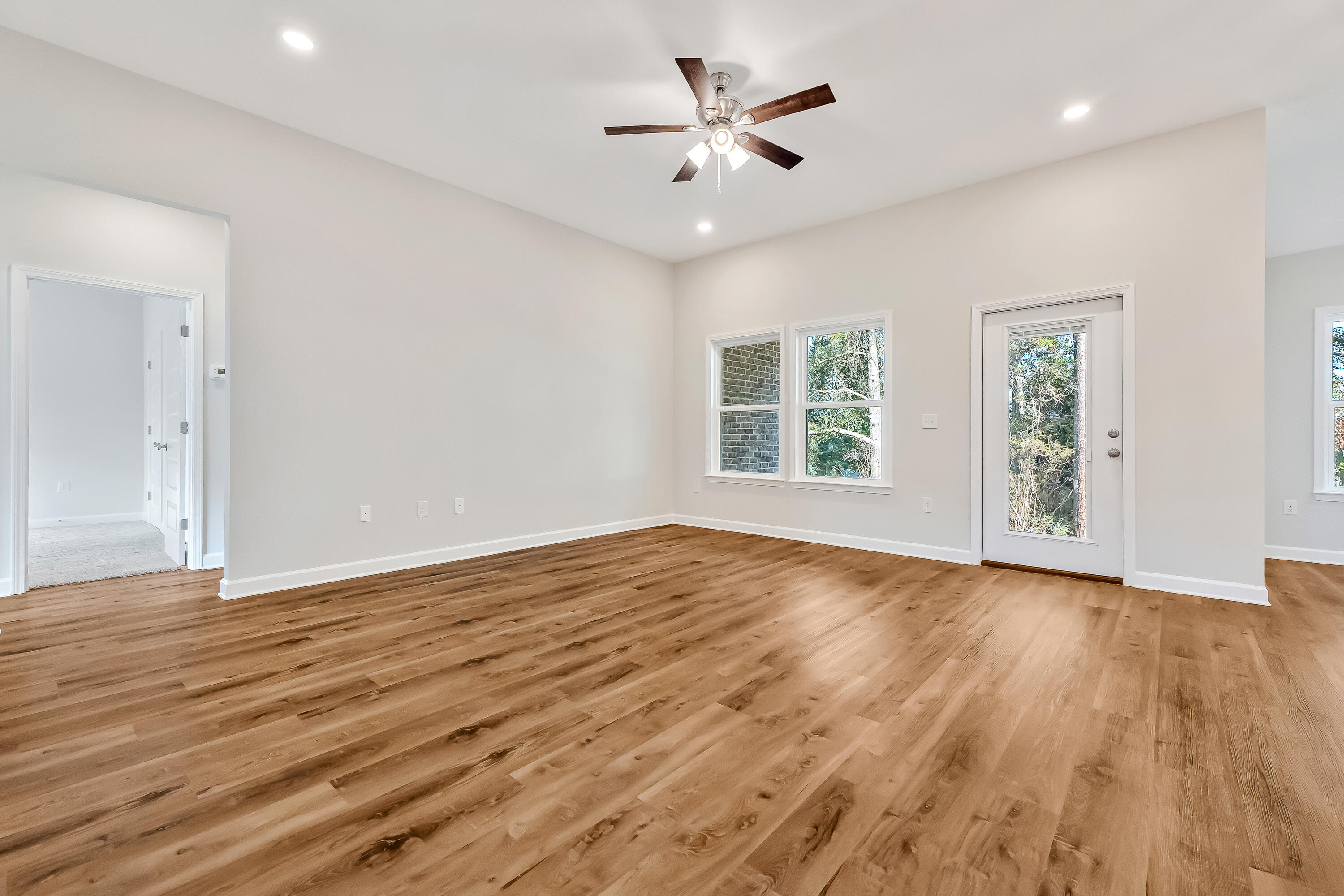 108 Huron Trail Crestview, FL 32536 - Photo 5 of 21 an empty room with wooden floor and windows