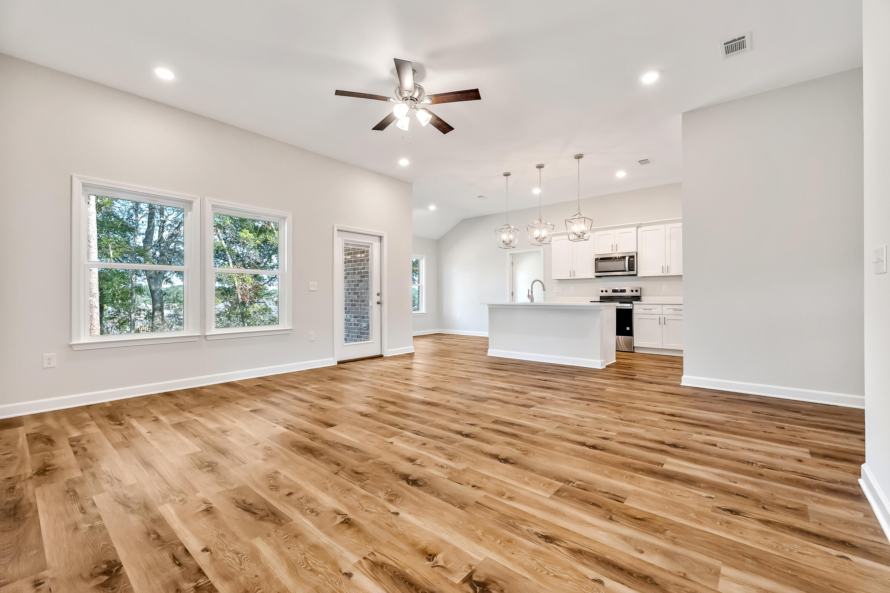 108 Huron Trail Crestview, FL 32536 - Photo 6 of 21 an empty room with wooden floor and windows