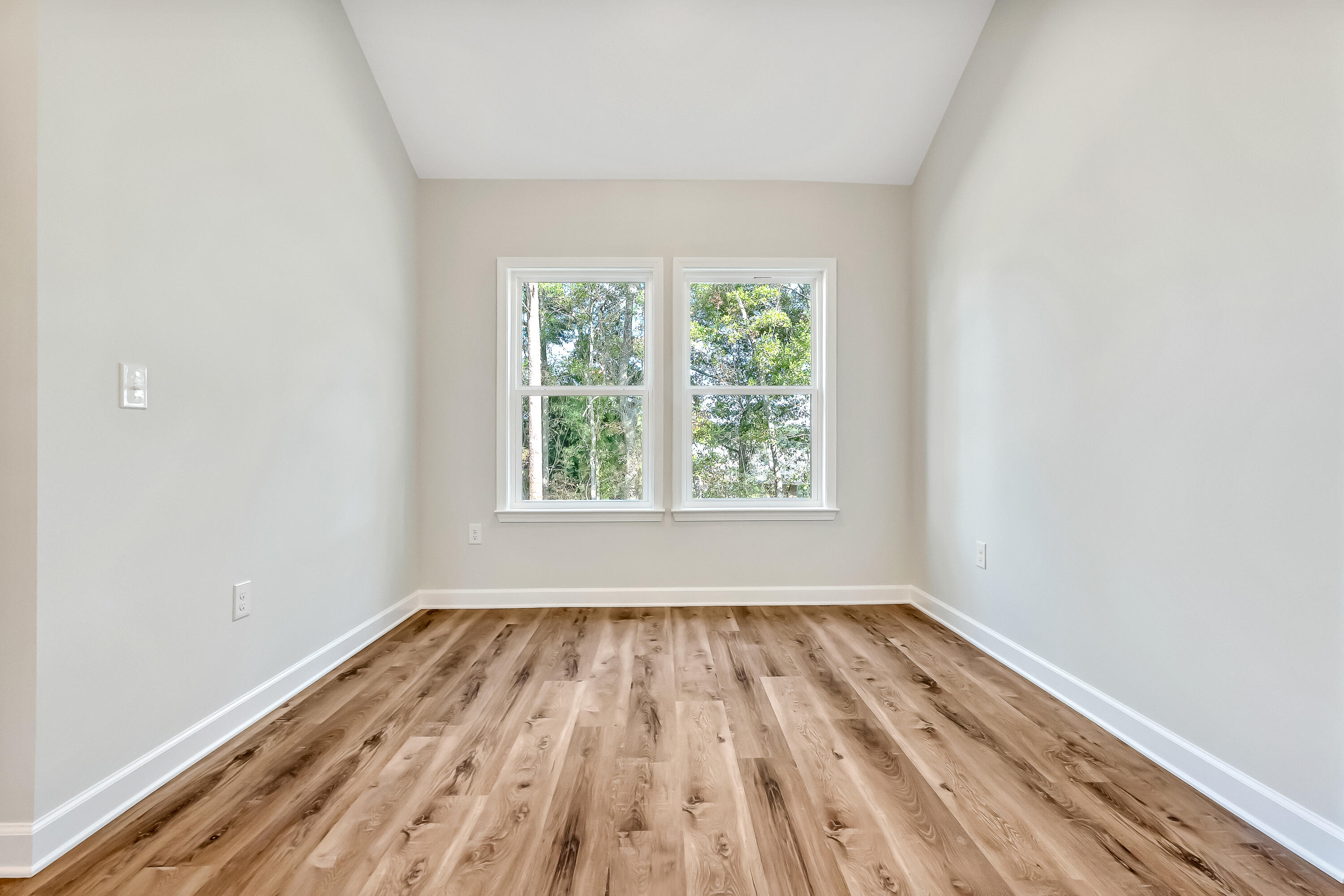 108 Huron Trail Crestview, FL 32536 - Photo 9 of 21 an empty room with wooden floor and windows