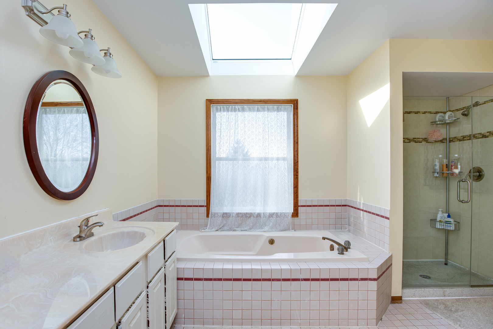 27W337 Churchill Road Winfield, IL 60190 - Photo 15 of 25 a bathroom with a tub sink and mirror