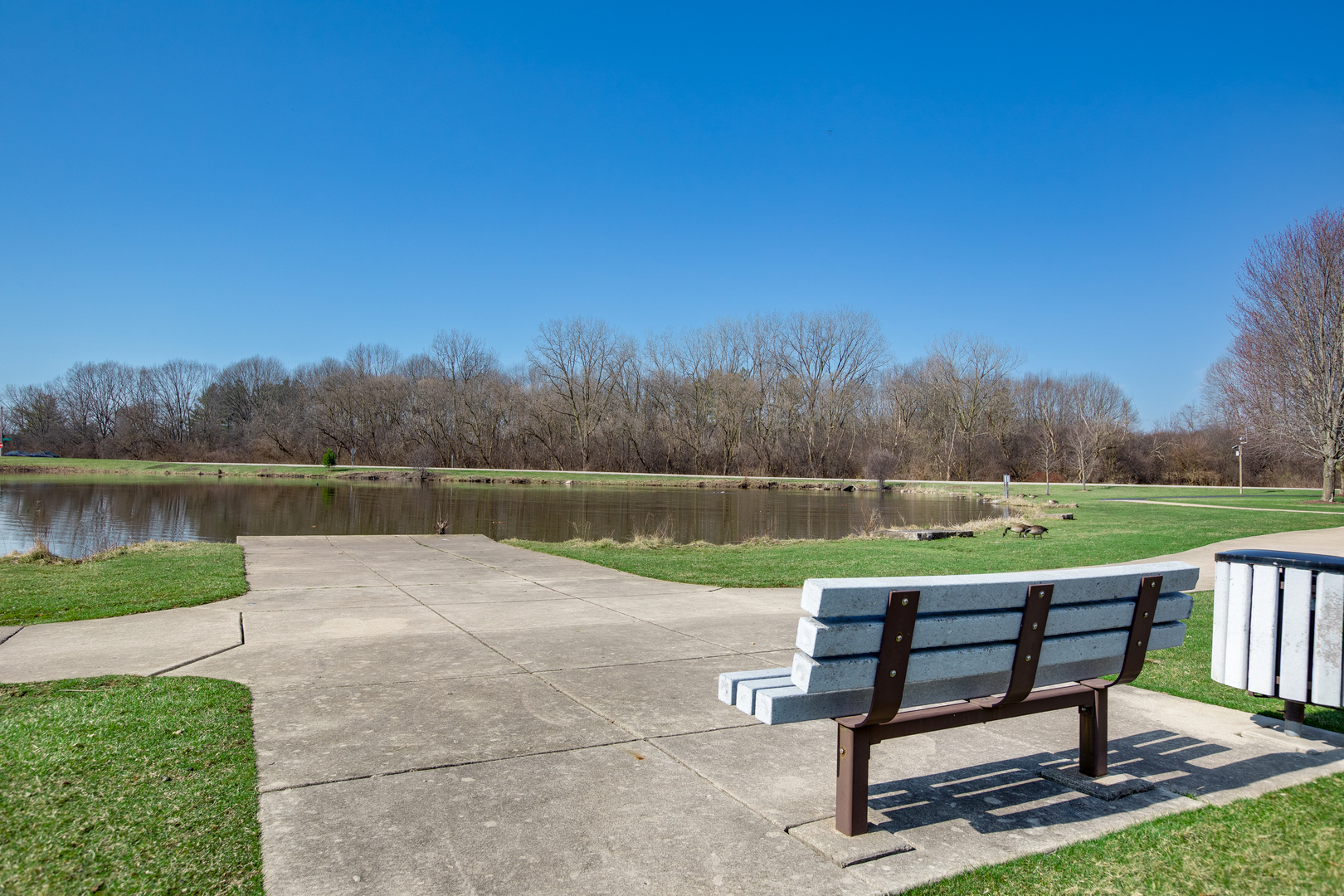 27W337 Churchill Road Winfield, IL 60190 - Photo 23 of 25 a view of a lake with outdoor space and a bench