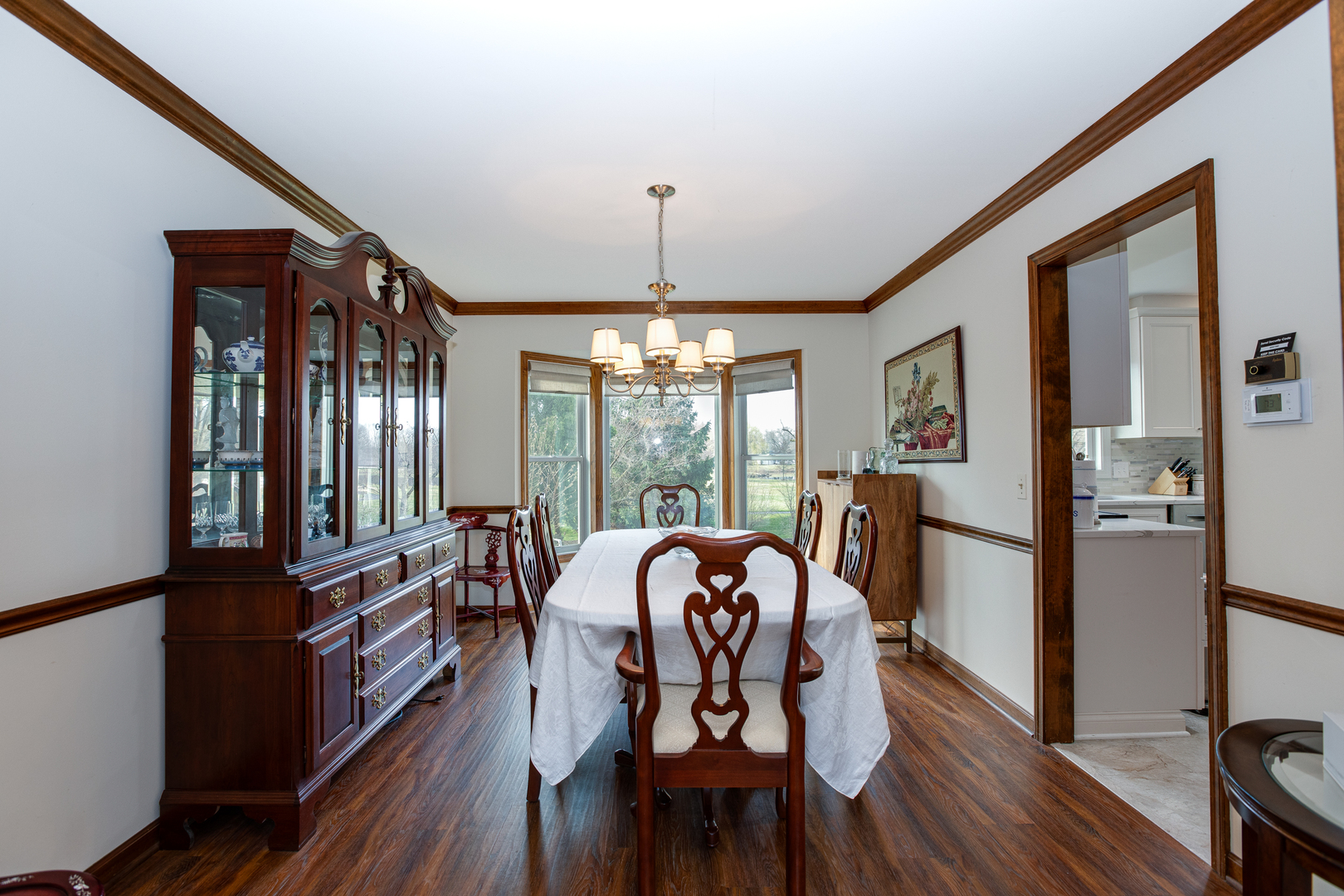27W337 Churchill Road Winfield, IL 60190 - Photo 8 of 25 a view of a dining room with furniture window and wooden floor