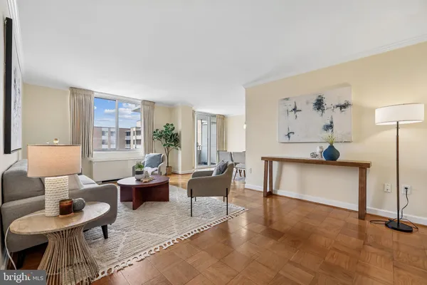 a living room with furniture a rug and a window