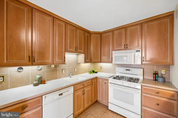 a kitchen with granite countertop a sink stainless steel appliances and cabinets