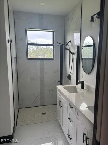 a bathroom with 2 sink and a mirror