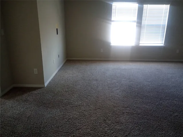 a large kitchen with stainless steel appliances a large counter top a sink and a wooden floors