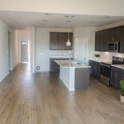 a view living room with stainless steel appliances wooden floors and view living room