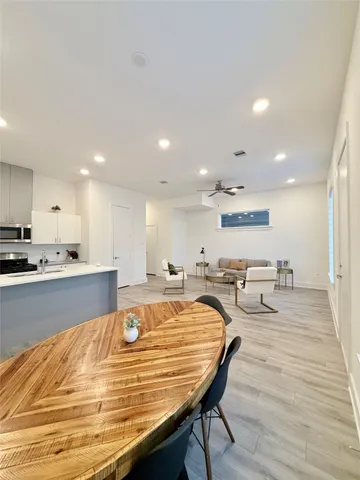 a room with stainless steel appliances furniture stove and wooden floor