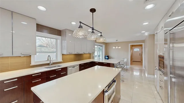 a kitchen with a sink a counter space and stainless steel appliances