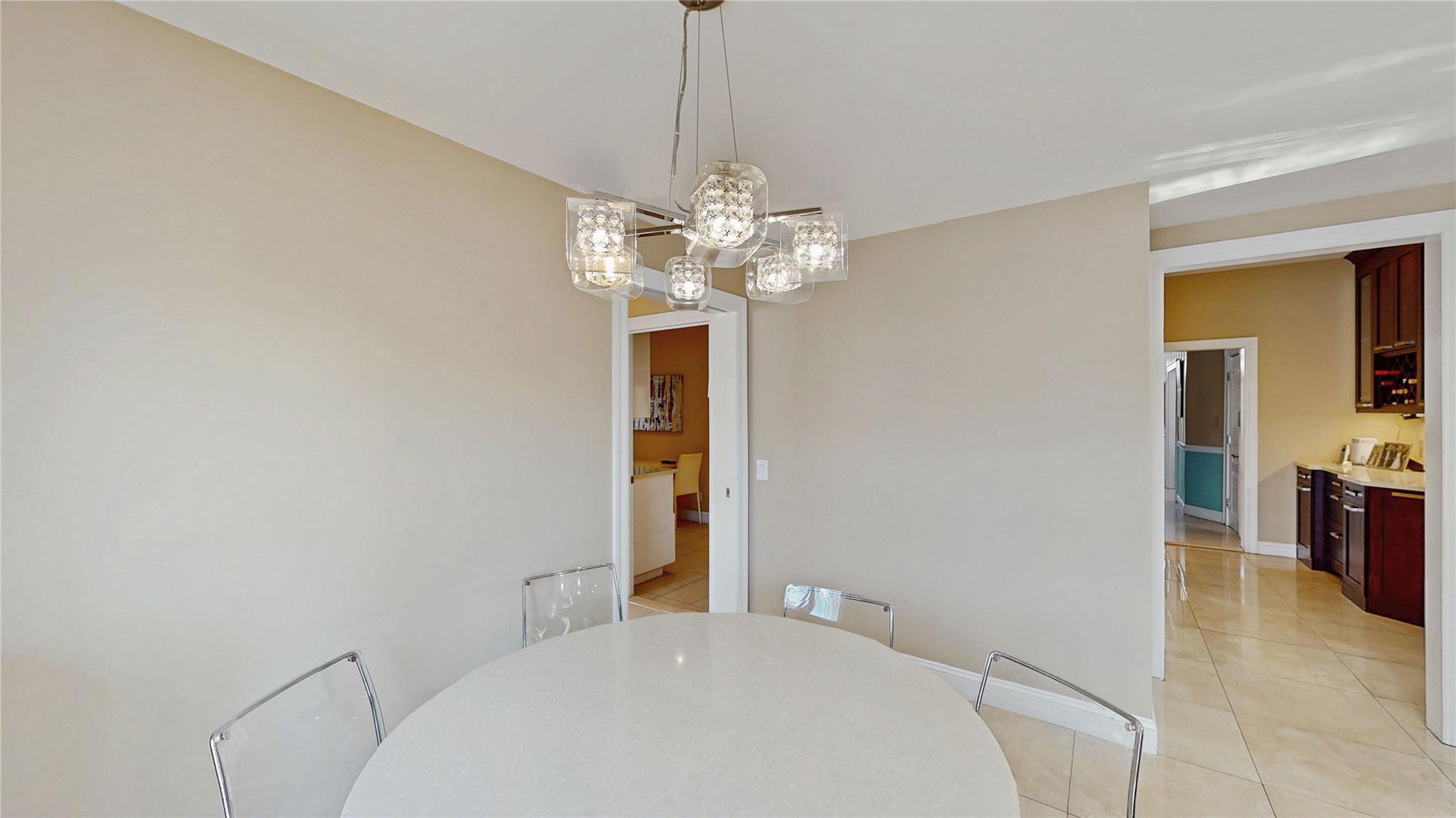 339 Midwood Road Woodmere, NY 11598 - Photo 17 of 49 a bedroom with a bed and a chandelier