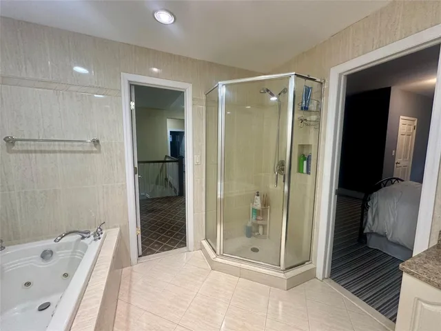 a bathroom with a tub and shower