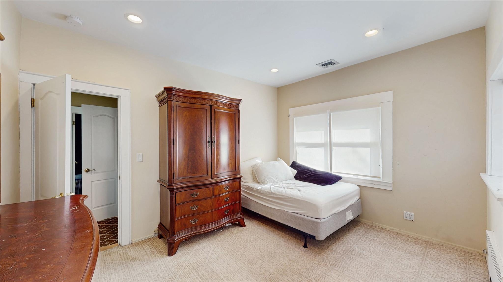 339 Midwood Road Woodmere, NY 11598 - Photo 30 of 49 a spacious bedroom with a bed and a couch