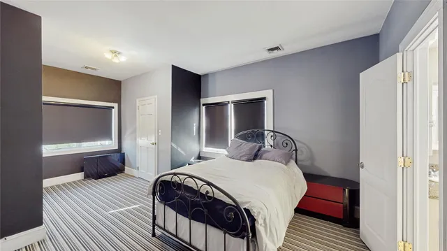 a bedroom with a bed and a closet