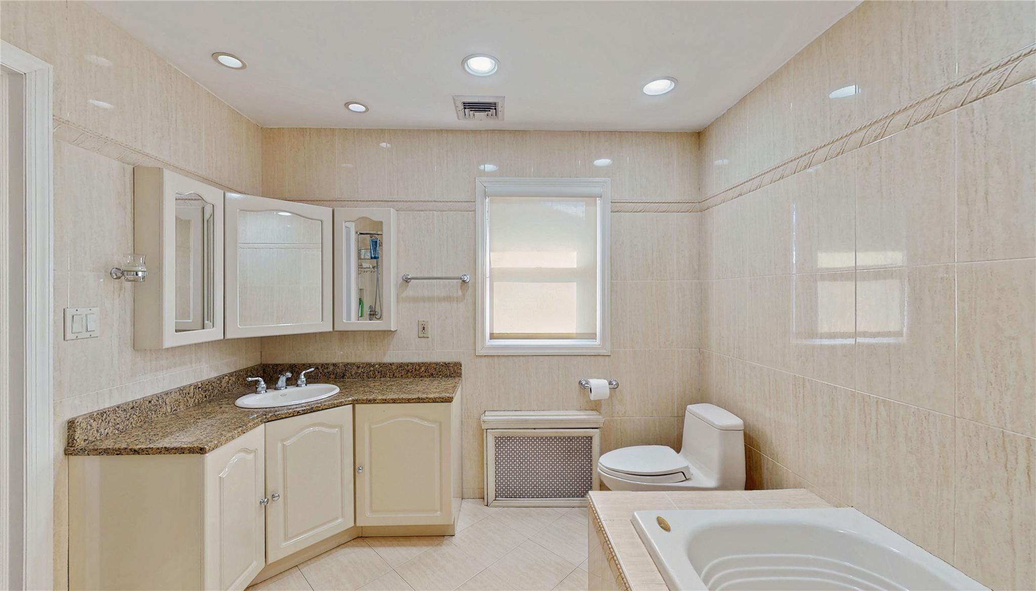 339 Midwood Road Woodmere, NY 11598 - Photo 35 of 49 a bathroom with a sink toilet and shower