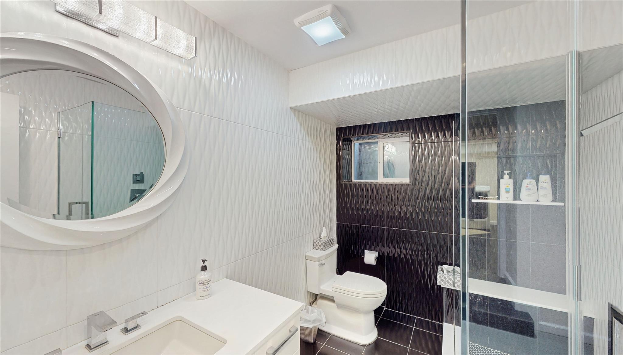 339 Midwood Road Woodmere, NY 11598 - Photo 46 of 49 a bathroom with a toilet and a sink