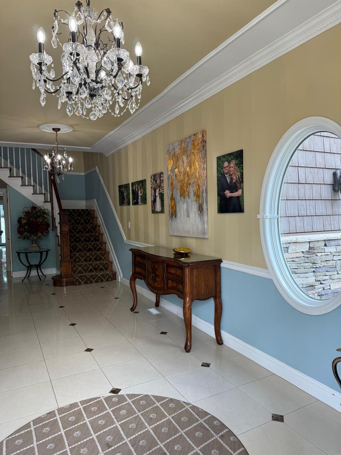 339 Midwood Road Woodmere, NY 11598 - Photo 5 of 49 a view of entryway with a chandelier