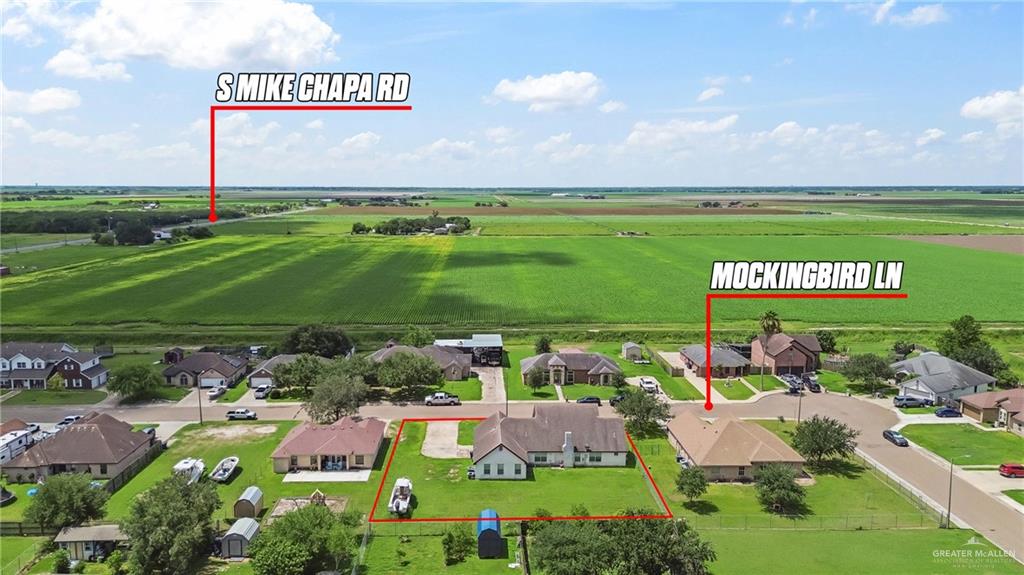 402 Mockingbird Lane Edcouch, TX 78538 - Photo 23 of 25 Aerial perspective of a single-story residence with a light-toned exterior and a hip roof, situated on a grassy lot