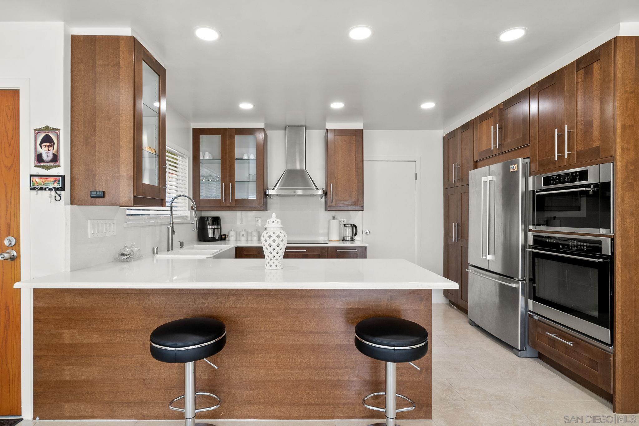 1407 5 D Drive El Cajon, CA 92021 - Photo 11 of 37 a kitchen with stainless steel appliances granite countertop a sink and a refrigerator