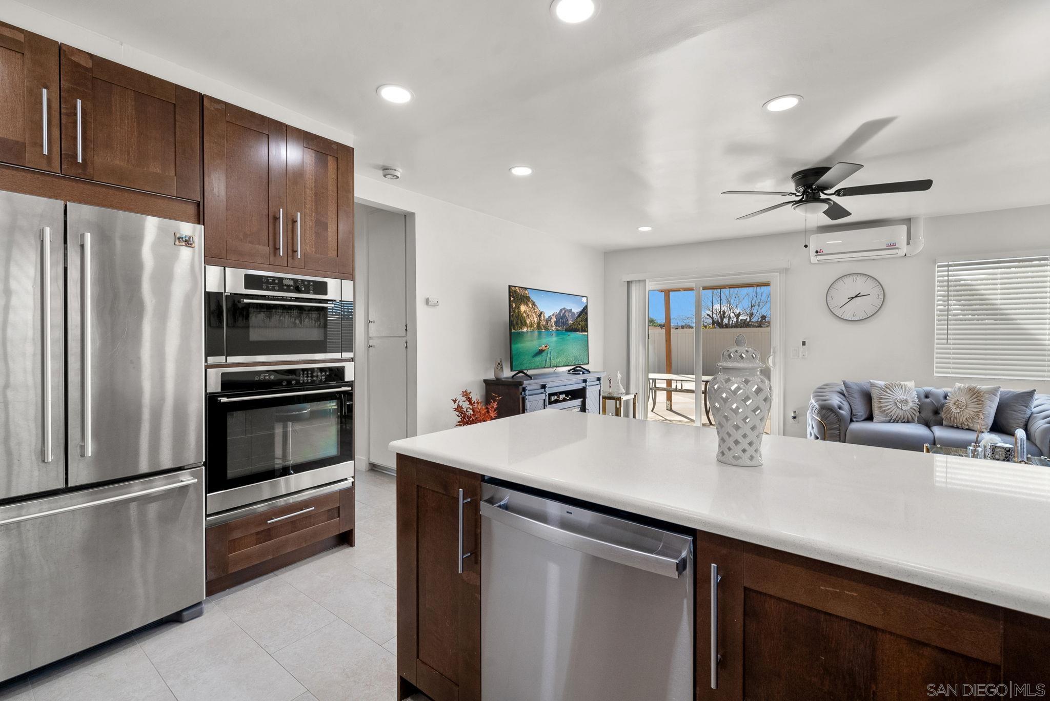 1407 5 D Drive El Cajon, CA 92021 - Photo 13 of 37 a kitchen with kitchen island a counter space a sink appliances and cabinets
